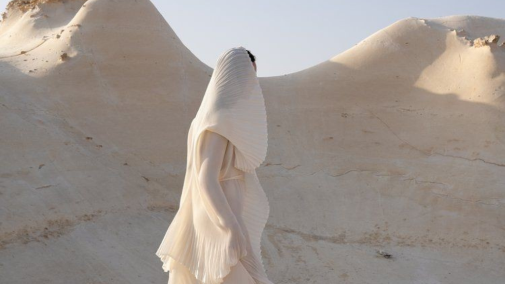 White sculptural fashion figure in desert landscape for a Coachella-inspired brand concept by Gesiggie